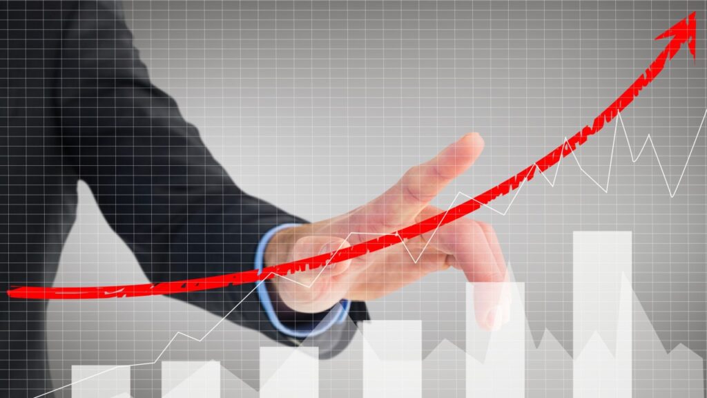business professional pointing at increasing graph